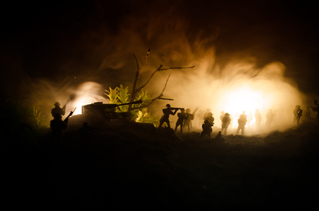War Concept. Military silhouettes fighting scene on war fog sky background, World War Soldiers Silhouettes Below Cloudy Skyline At night. Attack scene. Armored vehicles. Tanks battleの写真素材