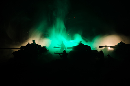 War Concept. Military silhouettes fighting scene on war fog sky background, World War Soldiers Silhouettes Below Cloudy Skyline At night. Attack scene. Armored vehicles. Tanks battleの写真素材
