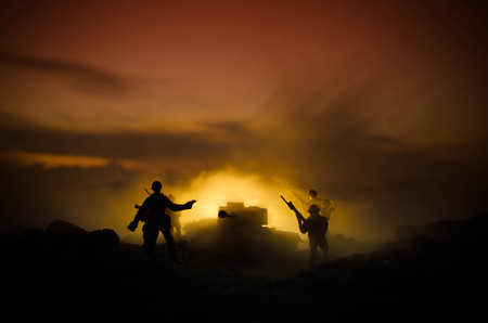 War Concept. Military silhouettes fighting scene on war fog sky background, World War Soldiers Silhouettes Below Cloudy Skyline At night. Attack scene. Armored vehicles. Tanks battle. Decorationの写真素材