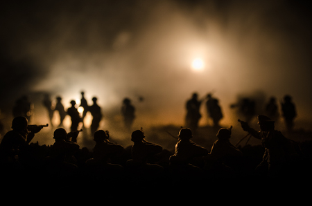 War Concept. Military silhouettes fighting scene on war fog sky background, World War Soldiers Silhouettes Below Cloudy Skyline At night. Attack scene. Armored vehicles. Tanks battleの写真素材