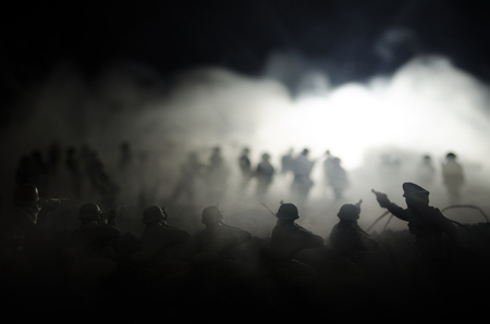 War Concept. Military silhouettes fighting scene on war fog sky background, World War Soldiers Silhouettes Below Cloudy Skyline At night. Attack scene. Armored vehicles. Tanks battleの写真素材