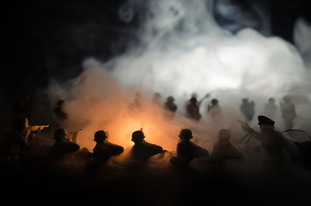 War Concept. Military silhouettes fighting scene on war fog sky background, World War Soldiers Silhouettes Below Cloudy Skyline At night. Attack scene. Armored vehicles. Tanks battleの写真素材