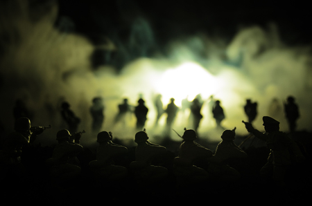 War Concept. Military silhouettes fighting scene on war fog sky background, World War Soldiers Silhouettes Below Cloudy Skyline At night. Attack scene. Armored vehicles. Tanks battleの写真素材
