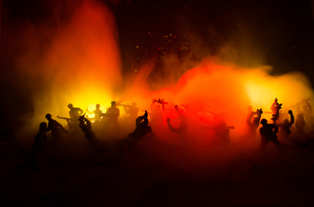 War Concept. Military silhouettes fighting scene on war fog sky background, World War Soldiers Silhouettes Below Cloudy Skyline At night. Attack scene. Armored vehicles. Tanks battleの写真素材