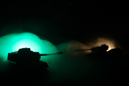 War Concept. Military silhouettes fighting scene on war fog sky background, World War Soldiers Silhouettes Below Cloudy Skyline At night. Attack scene. Armored vehicles. Tanks battleの写真素材