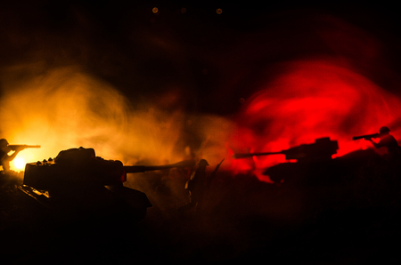 War Concept. Military silhouettes fighting scene on war fog sky background, World War Soldiers Silhouettes Below Cloudy Skyline At night. Attack scene. Armored vehicles. Tanks battleの写真素材
