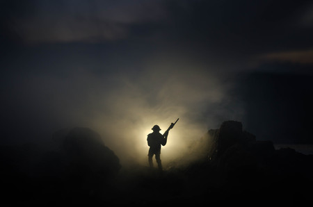 War Concept. Military silhouettes fighting scene on war fog sky background, World War Soldiers Silhouettes Below Cloudy Skyline At night. Attack scene. Armored vehicles. Tanks battle. Decorationの写真素材