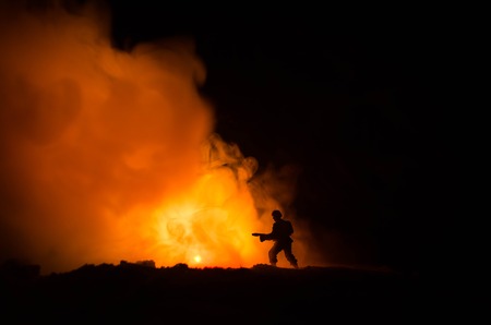 War Concept. Military silhouettes fighting scene on war fog sky background, World War Soldiers Silhouettes Below Cloudy Skyline At night. Attack scene. Armored vehicles. Tanks battle. Decorationの写真素材