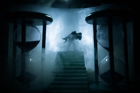 a silhouette of a man holding on to the woman. Rescue saviour concept. Escape from fire or danger. Surreal decorationの写真素材