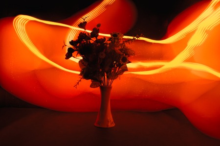 Picturesque purple spring flowers in glass vase standing in a row on a dark background with stars with light and fog. Flower concept with balloonの写真素材