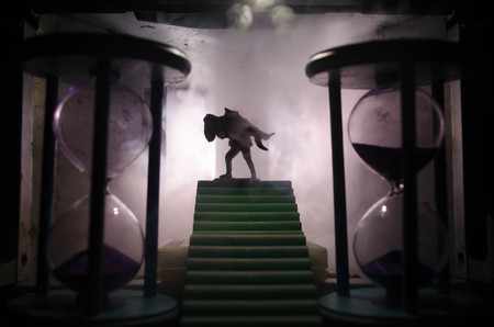 a silhouette of a man holding on to the woman. Rescue saviour concept. Escape from fire or danger. Surreal decorationの写真素材