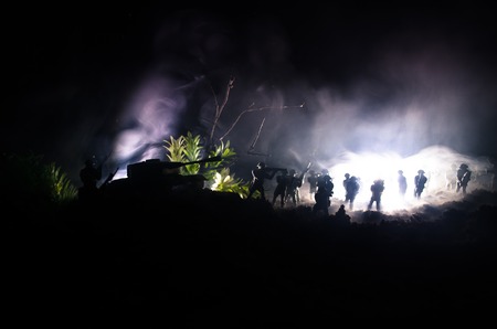 War Concept. Military silhouettes fighting scene on war fog sky background, World War Soldiers Silhouettes Below Cloudy Skyline At night. Attack scene. Armored vehicles. Tanks battleの写真素材