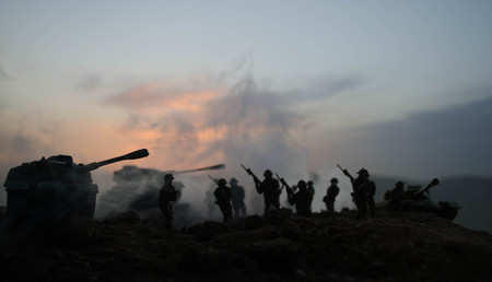 War Concept. Military silhouettes fighting scene on war fog sky background, World War Soldiers Silhouettes Below Cloudy Skyline At night. Attack scene. Armored vehicles. Tanks battle. Decorationの写真素材
