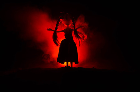 Silhouette of mysterious Woman, Horror scene of scary ghost doll woman on dark blue background with...