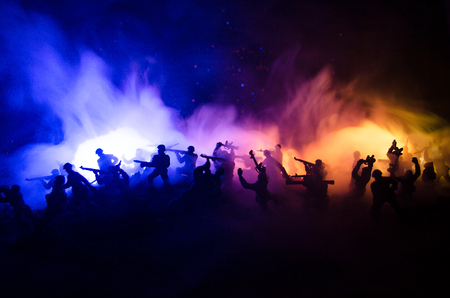 War Concept. Military silhouettes fighting scene on war fog sky background, World War Soldiers Silhouettes Below Cloudy Skyline At night. Attack scene. Armored vehicles. Tanks battleの写真素材