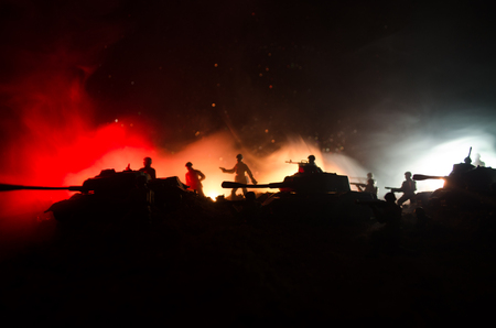 War Concept. Military silhouettes fighting scene on war fog sky background, World War Soldiers Silhouettes Below Cloudy Skyline At night. Attack scene. Armored vehicles. Tanks battleの写真素材