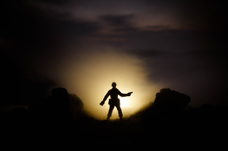 War Concept. Military silhouettes fighting scene on war fog sky background, World War Soldiers Silhouettes Below Cloudy Skyline At night. Attack scene. Armored vehicles. Tanks battle. Decorationの写真素材