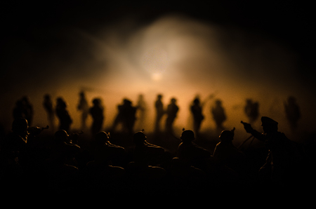 War Concept. Military silhouettes fighting scene on war fog sky background, World War Soldiers Silhouettes Below Cloudy Skyline At night. Attack scene. Armored vehicles. Tanks battleの写真素材