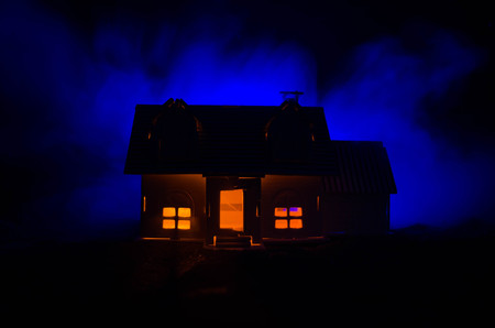 Old house with a Ghost in the moonlit night or Abandoned Haunted Horror House in fog. Old mystic villa with surreal big full moon. Horror Halloween concept.の写真素材