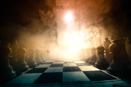chess board game concept of business ideas and competition and strategy ideas concep. Chess figures on a dark background with smoke and fog. Selective focusの写真素材