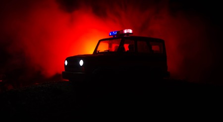 Anti-riot police give signal to be ready. Government power concept. Police in action. Smoke on a dark background with lights. Blue red flashing sirens. Dictatorship powerの写真素材
