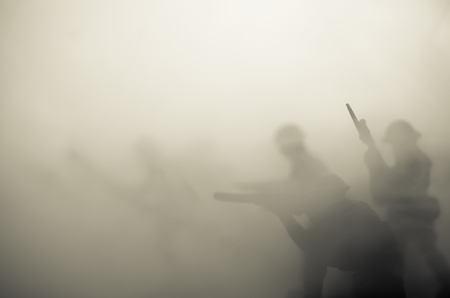 War Concept. Military silhouettes fighting scene on war fog sky background, World War Soldiers Silhouettes Below Cloudy Skyline At night. Attack scene. Armored vehicles. Tanks battleの写真素材
