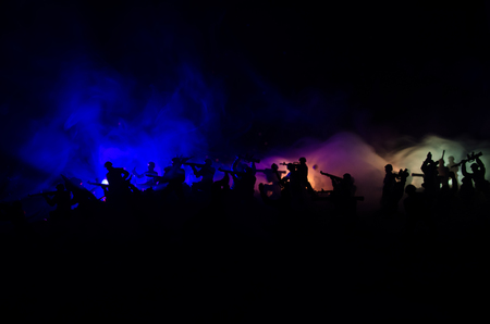 War Concept. Military silhouettes fighting scene on war fog sky background, World War Soldiers Silhouettes Below Cloudy Skyline At night. Attack scene. Armored vehicles. Tanks battleの写真素材