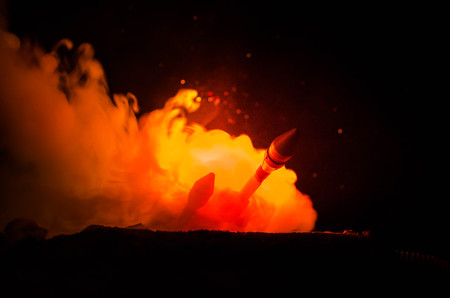 Rocket launch with fire clouds. Nuclear Missiles With Warhead Aimed at Gloomy Sky at night. Balistic Rockets War Backgound.の写真素材