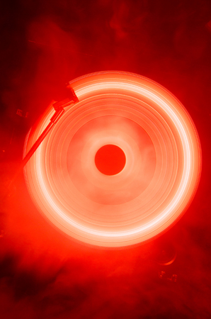 Concept of speed - Trail of fire and smoke - Vinyl record. Burning vinyl disk. Turntable vinyl record player. Retro audio equipment for disc jockey. Sound technologyの写真素材