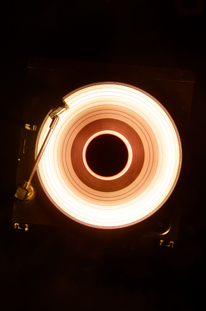 Concept of speed - Trail of fire and smoke - Vinyl record. Burning vinyl disk. Turntable vinyl record player. Retro audio equipment for disc jockey. Sound technologyの写真素材
