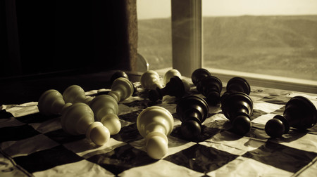 chess board game concept of business ideas and competition and strategy ideas concep. Chess figures on a dark background with smoke and fog and window with sunlight. Selective focusの写真素材