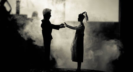Doll wedding couple indoors is hugging each other. Beautiful model girl in white dress. Man in suit. Wedding love concept. Close up, smoke on background. Selective focusの写真素材