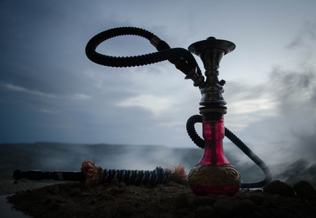 Hookah, traditional arabic waterpipe, direct sunset light, outdoor photo. Mountain backgroundの写真素材
