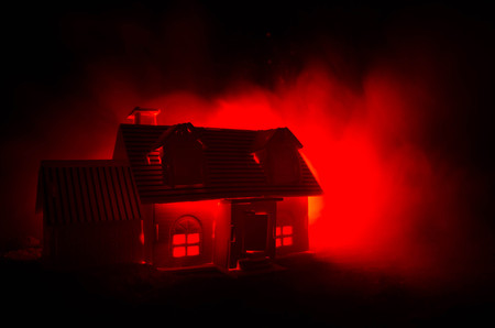 Old house with a Ghost in the moonlit night or Abandoned Haunted Horror House in fog. Old mystic villa with surreal big full moon. Horror Halloween concept.の写真素材