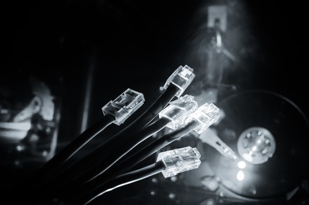 Network switch and ethernet cables, symbol of global communications. Colored network cables on dark background with lights and smoke. Selective focus. Network internet concept backgroundの写真素材