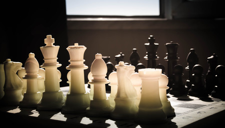 chess board game concept of business ideas and competition and strategy ideas concep. Chess figures on a dark background with smoke and fog. Selective focusの写真素材