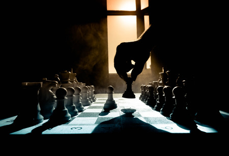 chess board game concept of business ideas and competition and strategy ideas concep. Chess figures on a dark background with smoke and fog. Selective focusの写真素材