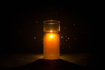 bright yellow green cocktail garnished with lime. Classic alcohol cocktails, cocktails at the bar, alcoholic drinks, soft drinks, tasty cocktails on dark background with smoke and lightの写真素材