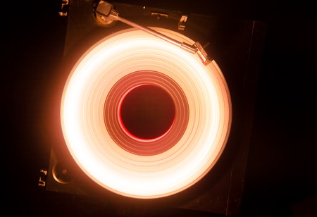 Concept of speed - Trail of fire and smoke - Vinyl record. Burning vinyl disk. Turntable vinyl record player. Retro audio equipment for disc jockey. Sound technologyの写真素材