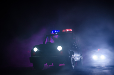 speed lighting of police car in the night on the road. Police cars on road moving with fog. Selective focusの写真素材