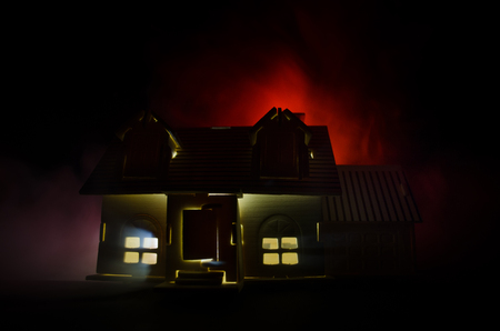 Old house with a Ghost in the moonlit night or Abandoned Haunted Horror House in fog. Old mystic villa with surreal big full moon. Horror Halloween concept.の写真素材