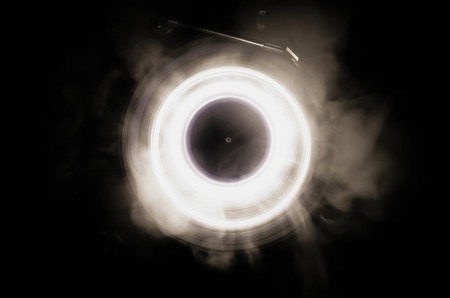 Concept of speed - Trail of fire and smoke - Vinyl record. Burning vinyl disk. Turntable vinyl record player. Retro audio equipment for disc jockey. Sound technologyの写真素材