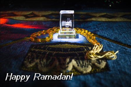 Holy Quran with beads on a prayer mat, Muslim Tasbih is a string of prayer beads which is traditionally used by Muslims along with the Quran. Ramadan holidays concept. Selective focusの写真素材