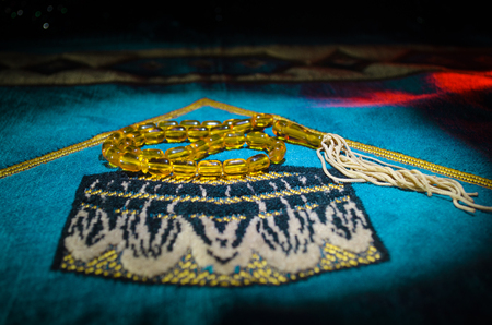 Holy Quran with beads on a prayer mat, Muslim Tasbih is a string of prayer beads which is traditionally used by Muslims along with the Quran. Ramadan holidays concept. Selective focusの写真素材