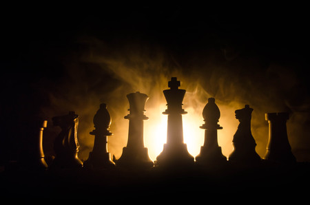 chess board game concept of business ideas and competition and strategy ideas concep. Chess figures on a dark background with smoke and fog. Selective focusの写真素材