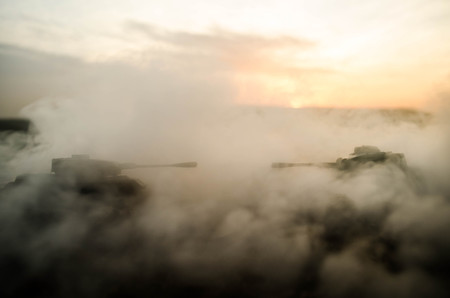 War Concept. Military silhouettes fighting scene on war fog sky background, World War Soldiers Silhouettes Below Cloudy Skyline At night. Attack scene. Armored vehicles. Tanks battle. Decorationの写真素材
