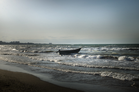 Beautiful landscape of Boat on the beach in cloudy weather. Vintage Boat in the seashore. Azerbaijan Caspian Seaの写真素材