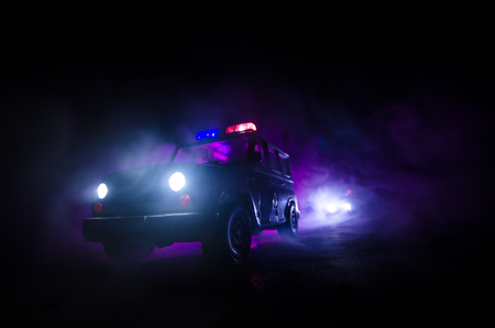 speed lighting of police car in the night on the road. Police cars on road moving with fog. Selective focusの写真素材