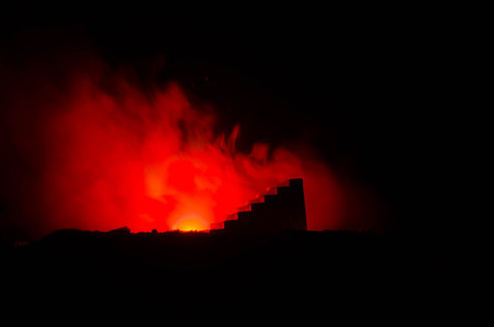 a silhouette of a man holding on to the woman. Rescue saviour concept. Escape from fire or danger. Surreal decorationの写真素材