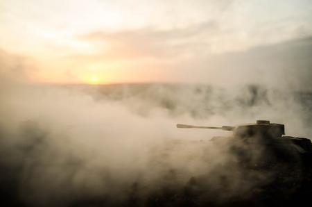 War Concept. Military silhouettes fighting scene on war fog sky background, World War Soldiers Silhouettes Below Cloudy Skyline At night. Attack scene. Armored vehicles. Tanks battle. Decorationの写真素材